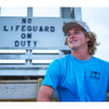 Surfer wearing Wrightsville Beach Tee