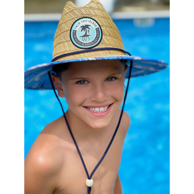 Boy using straw hat protect against sun at Wrightsville Beach